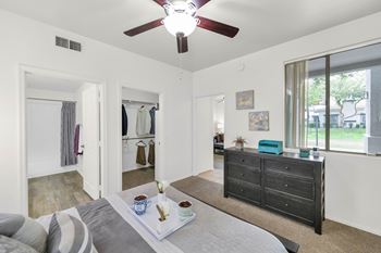 Bedroom with walk-in closet and ceiling fan